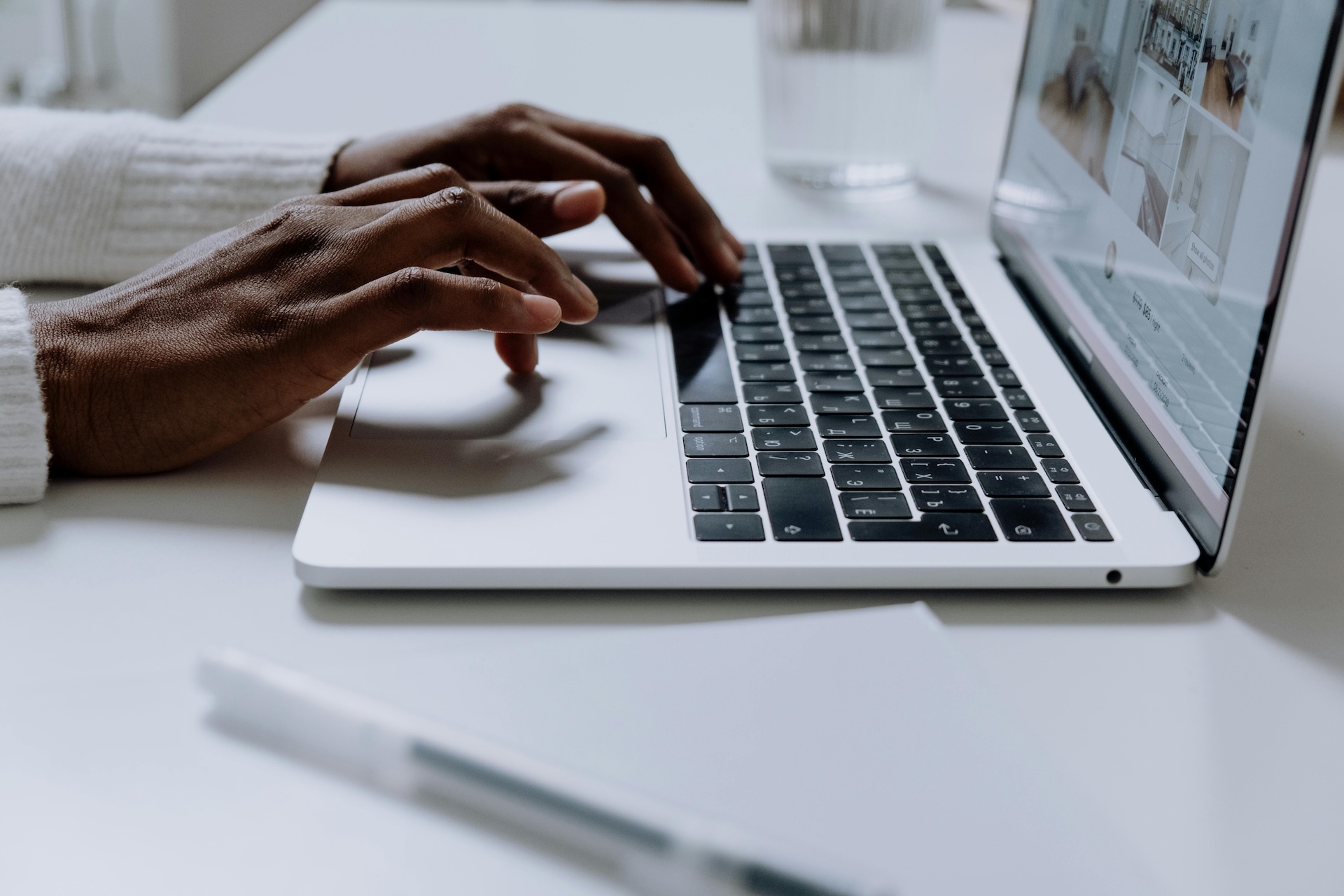 Landscape photo of a woman's hands typing on a laptop