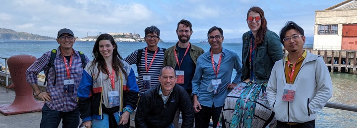 Group photo of Nitid members attending a conference on an ocean pier.